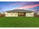 Home exterior overlooking a green lawn with a covered patio at 3700 Long Lake Dr, Douglasville, GA 30135