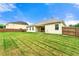 Exterior shot of a large green lawn and a covered patio at 3700 Long Lake Dr, Douglasville, GA 30135