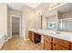Bathroom with double sinks, a large mirror, and tile flooring at 3700 Long Lake Dr, Douglasville, GA 30135
