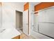 Bathroom with orange accent wall, shower with sliding glass door and vanity with white sink at 3700 Long Lake Dr, Douglasville, GA 30135