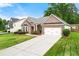 Attractive brick home with a well-maintained lawn and a driveway leading to a two-car garage at 3700 Long Lake Dr, Douglasville, GA 30135