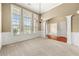 Bright and airy living room with tall windows, an arched doorway, and plush carpeting at 3700 Long Lake Dr, Douglasville, GA 30135