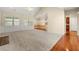Spacious living room with a vaulted ceiling, hardwood floors, and a view of the kitchen at 3700 Long Lake Dr, Douglasville, GA 30135