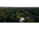 Aerial view of a grand estate nestled amongst lush greenery, showcasing its expansive grounds at 490 Mount Paran Rd, Atlanta, GA 30327