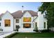 Back exterior view of an elegant brick home featuring a patio with an outdoor dining set and a well-maintained lawn at 490 Mount Paran Rd, Atlanta, GA 30327
