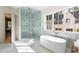 Luxurious bathroom with glass-enclosed shower, soaking tub, marble finishes, and ample natural light at 490 Mount Paran Rd, Atlanta, GA 30327