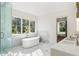 Serene bathroom featuring a soaking tub, marble accents, and a spacious vanity at 490 Mount Paran Rd, Atlanta, GA 30327