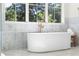 The bathroom features a soaking tub with a marble backsplash, windows, and a light fixture at 490 Mount Paran Rd, Atlanta, GA 30327