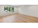 Spacious bedroom with hardwood flooring and a large window offering views of lush greenery at 490 Mount Paran Rd, Atlanta, GA 30327