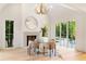 Bright dining area with fireplace, chandelier, and floor-to-ceiling windows with an outdoor view at 490 Mount Paran Rd, Atlanta, GA 30327