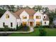 Stunning white brick home with a well-manicured lawn, professional landscaping, and a stone accented entrance at 490 Mount Paran Rd, Atlanta, GA 30327