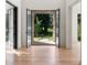 Elegant entryway featuring hardwood floors and a view of the landscaped backyard through steel doors at 490 Mount Paran Rd, Atlanta, GA 30327