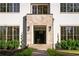 Elegant entryway with stone accents and professionally landscaped garden beds at 490 Mount Paran Rd, Atlanta, GA 30327