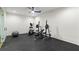 Home gym with ceiling fan, weights, bench, and elliptical trainer at 490 Mount Paran Rd, Atlanta, GA 30327