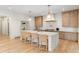 Spacious kitchen with central island, breakfast bar, stylish lighting, and stainless steel appliances at 490 Mount Paran Rd, Atlanta, GA 30327