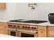 Stainless steel kitchen with tiled backsplash, red knobs, and professional grade appliances at 490 Mount Paran Rd, Atlanta, GA 30327