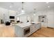 Open-concept kitchen island with white cabinets and living room view at 490 Mount Paran Rd, Atlanta, GA 30327