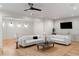 Bright living room featuring neutral walls, recessed lighting, and hardwood floors, with a ceiling fan and two couches at 490 Mount Paran Rd, Atlanta, GA 30327