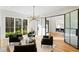 Sophisticated living room with modern light fixture, hardwood floors and access to dining room with glass doors at 490 Mount Paran Rd, Atlanta, GA 30327