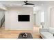 Bright living room boasts hardwood floors, a ceiling fan, a neutral color scheme and modern decor at 490 Mount Paran Rd, Atlanta, GA 30327
