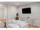 The stylish living room features built-in cabinets, mini-fridge, counter space, a sink, and a wall mounted television at 490 Mount Paran Rd, Atlanta, GA 30327