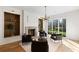 Bright living room featuring a fireplace, built-in shelves, and large windows with views of landscaped yard at 490 Mount Paran Rd, Atlanta, GA 30327