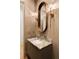 Stylish powder room features marble countertop, decorative lighting, and a unique oval mirror at 490 Mount Paran Rd, Atlanta, GA 30327