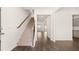 Inviting entryway showcasing the staircase, hardwood floors, and an open floor plan to the living areas at 628 Kimberwick Dr, Locust Grove, GA 30248
