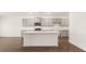 A modern kitchen with an island, stainless steel appliances, and gray cabinetry at 628 Kimberwick Dr, Locust Grove, GA 30248