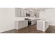 A modern kitchen with an island, stainless steel appliances, and gray cabinetry at 628 Kimberwick Dr, Locust Grove, GA 30248