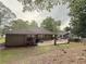 Beautiful backyard featuring a stained concrete patio, wooden deck and mature trees at 1341 Beeblossom Trl, Lawrenceville, GA 30044