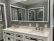 Bright bathroom featuring double vanity, modern lighting, and sleek fixtures at 1341 Beeblossom Trl, Lawrenceville, GA 30044