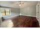 Bright bedroom with hardwood floors, neutral paint, and a ceiling fan for added comfort at 1341 Beeblossom Trl, Lawrenceville, GA 30044