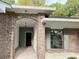 Charming brick home featuring an arched entryway with modern fixtures and covered porch at 1341 Beeblossom Trl, Lawrenceville, GA 30044