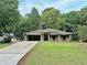 Charming single-story home with a well-manicured front lawn, attached garage, and brick facade at 1341 Beeblossom Trl, Lawrenceville, GA 30044