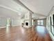 Open living room boasts vaulted ceilings, hardwood floors, fireplace, and elegant chandelier at 1341 Beeblossom Trl, Lawrenceville, GA 30044