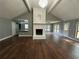 Spacious living room with vaulted ceiling, fireplace, wood floors, and natural light from multiple windows at 1341 Beeblossom Trl, Lawrenceville, GA 30044