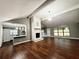 Bright, open living room featuring a brick fireplace, hardwood floors, and vaulted ceilings at 1341 Beeblossom Trl, Lawrenceville, GA 30044