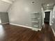 Open living space features dark hardwood floors and a glass display cabinet at 1341 Beeblossom Trl, Lawrenceville, GA 30044