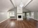 Spacious living room showcasing hardwood floors, fireplace, and an elegant chandelier at 1341 Beeblossom Trl, Lawrenceville, GA 30044