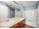 Bright bathroom with double sinks, a large mirror, and a shower-tub combination at 4670 Ernest Dr, Forest Park, GA 30297