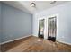Bright bedroom with hardwood floors and access to the outside through double doors at 4670 Ernest Dr, Forest Park, GA 30297