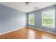 Charming bedroom featuring wood-look floors and two large windows that offer a lot of natural light at 4670 Ernest Dr, Forest Park, GA 30297