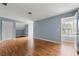 Open bonus room with wood-look flooring and access to additional storage and natural light from a window at 4670 Ernest Dr, Forest Park, GA 30297