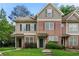 Traditional townhome with brick and vinyl siding, covered entrances, and well-maintained landscaping at 4670 Ernest Dr, Forest Park, GA 30297