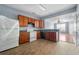Open-concept kitchen with wood cabinetry, appliances, and view into the living room at 4670 Ernest Dr, Forest Park, GA 30297