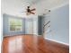 Open floor plan featuring hardwood floors, a ceiling fan, and a staircase in a light-filled space at 4670 Ernest Dr, Forest Park, GA 30297