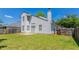 Back exterior of two-story home with a well-maintained lawn and wooden fence at 4915 Truitt Ln, Decatur, GA 30035