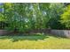 Overgrown backyard with wooden fence at 4915 Truitt Ln, Decatur, GA 30035