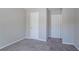 Neutral bedroom featuring carpet flooring and two doors at 4915 Truitt Ln, Decatur, GA 30035